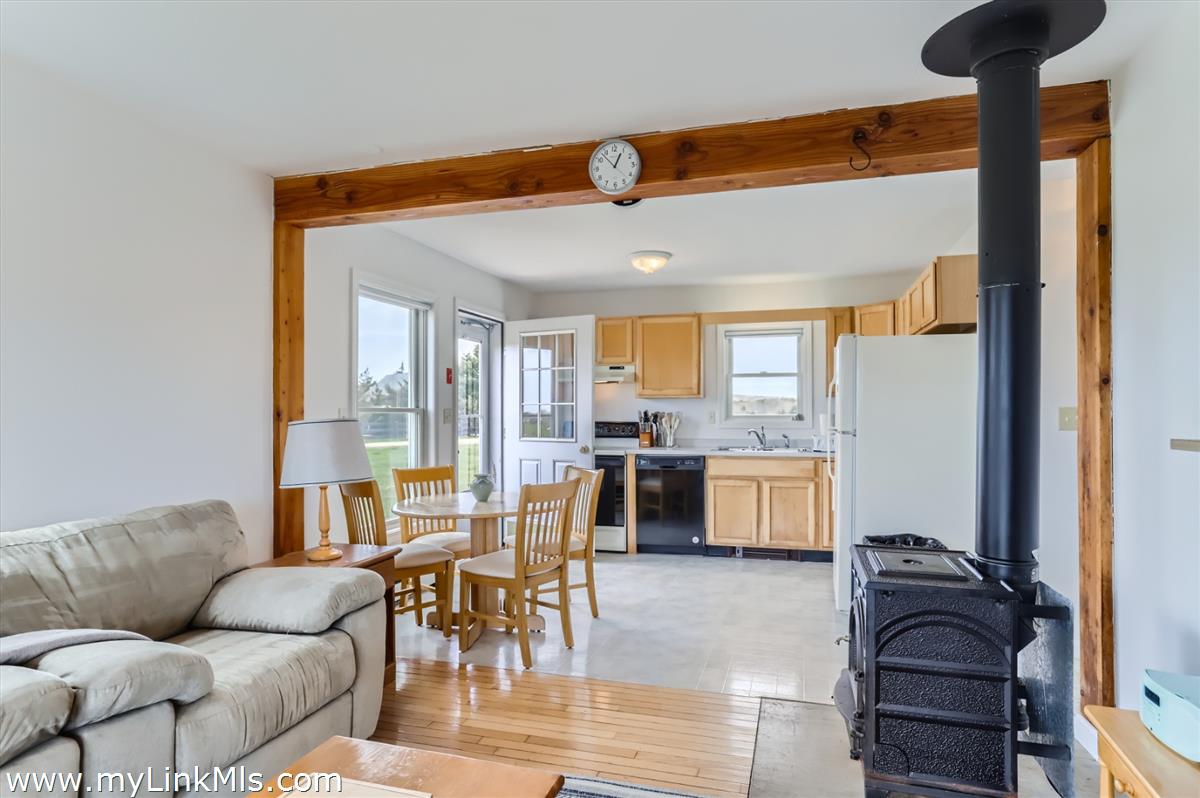 104 Pond View Farm Road West Tisbury, MA 02568 - Photo 43 of 55 a living room with furniture and a dining table next to a window
