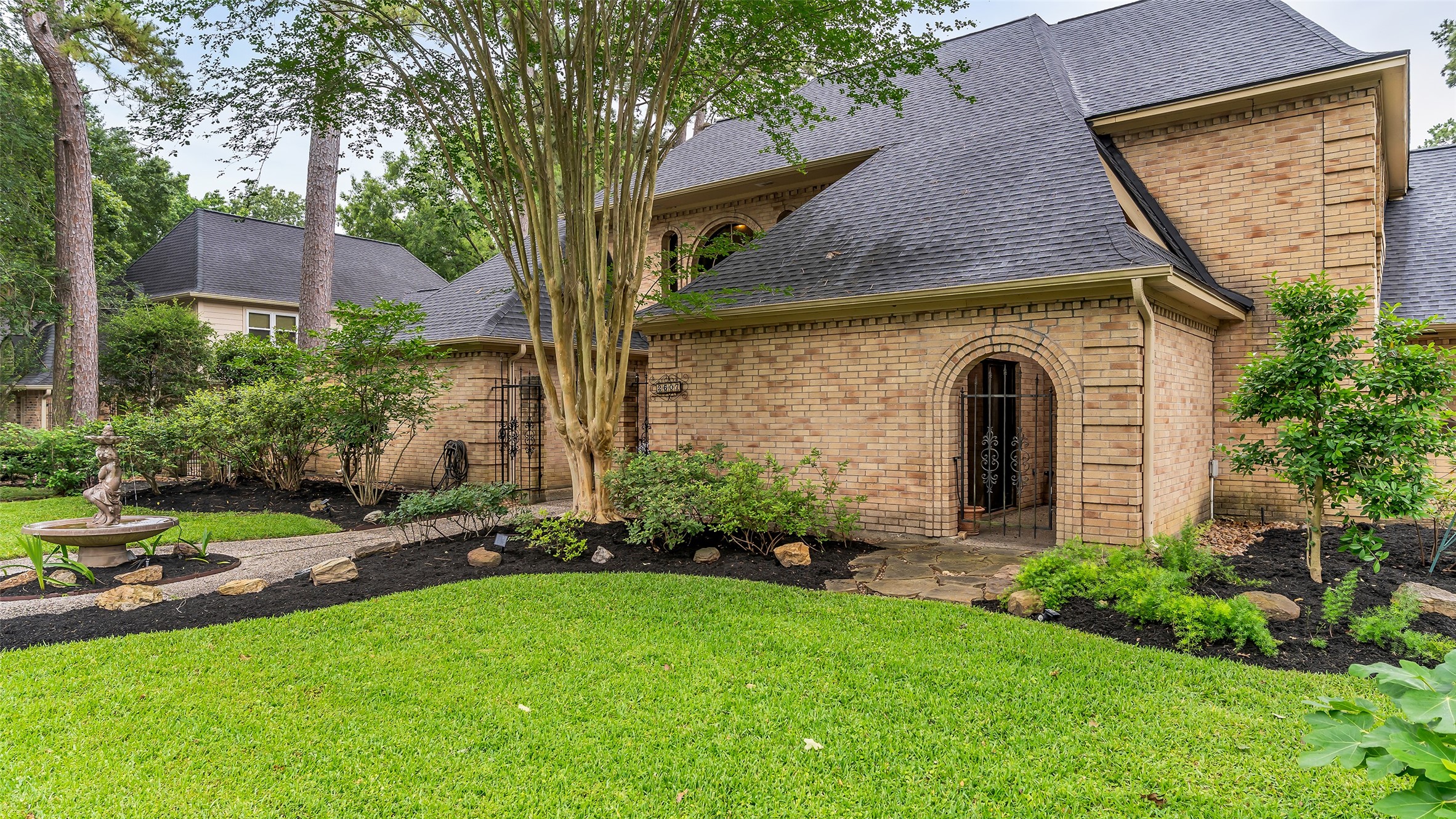 2607 Laurel Ridge Drive Houston, TX 77345 - Photo 3 of 47 a front view of a house with garden