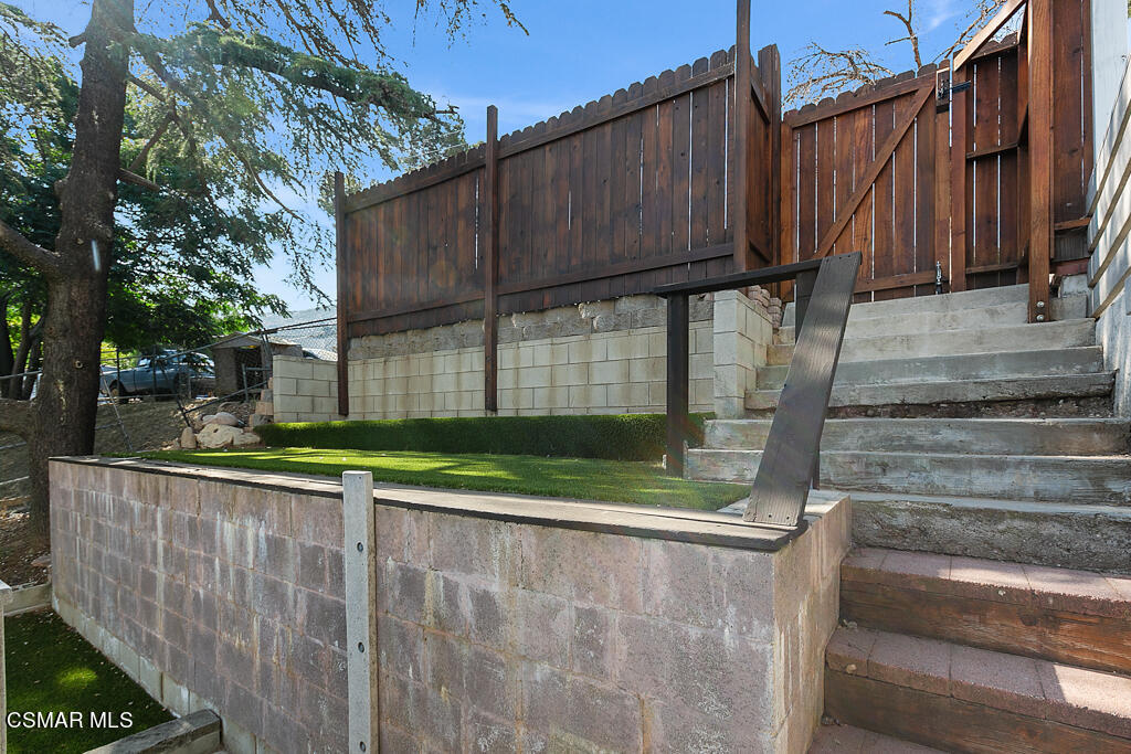 6314 Alta Vista Road Simi Valley, CA 93063 - Photo 34 of 39 a view of a house with a small yard and wooden fence