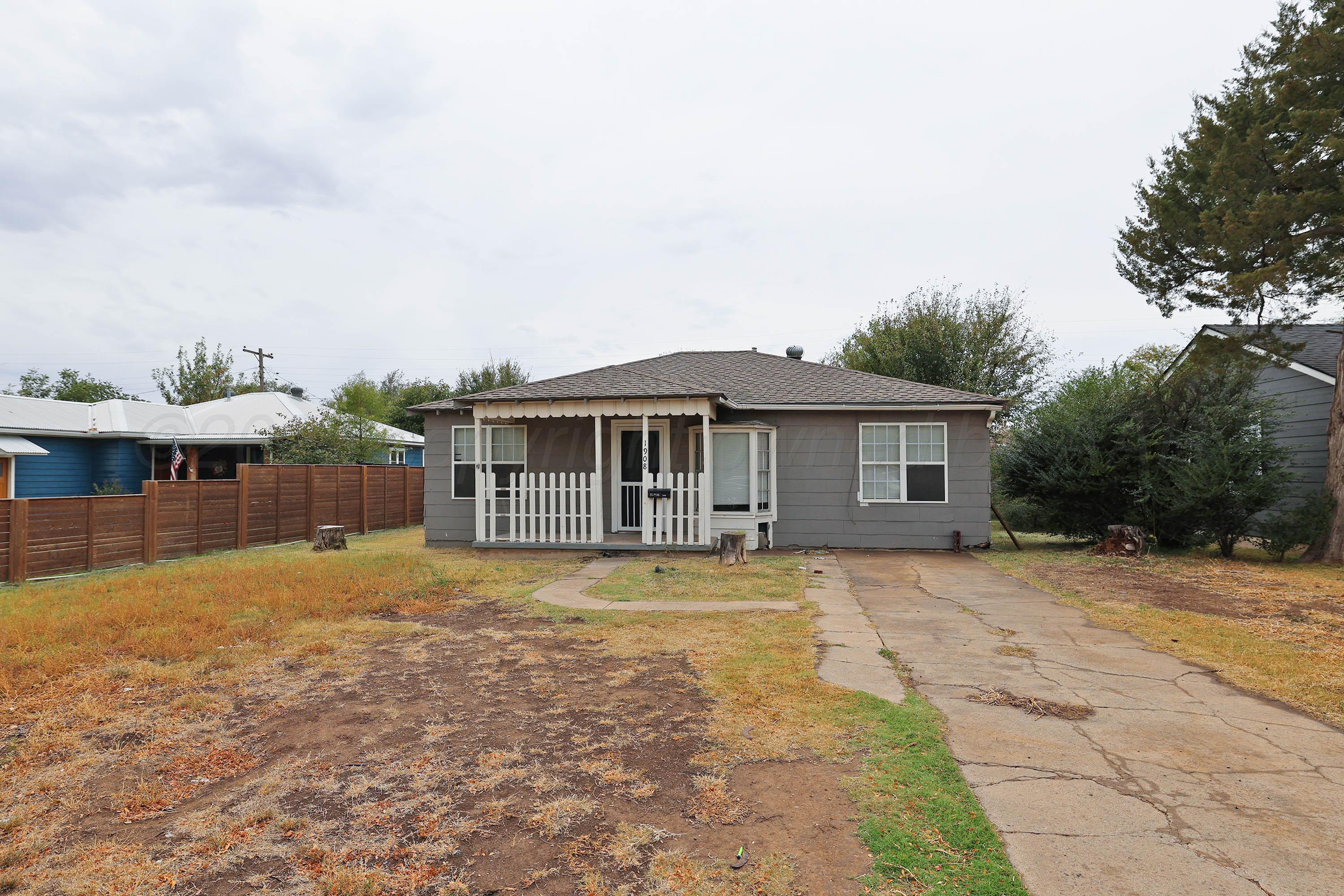a front view of a house with a yard garage and outdoor seating