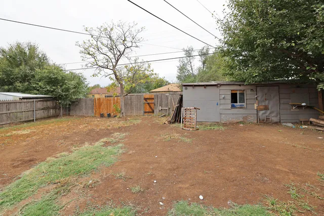 a backyard of a house with table and chairs