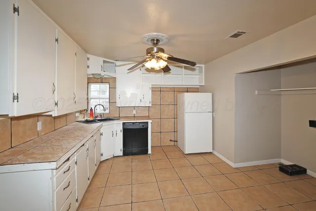 a kitchen with a white cabinets and white appliances