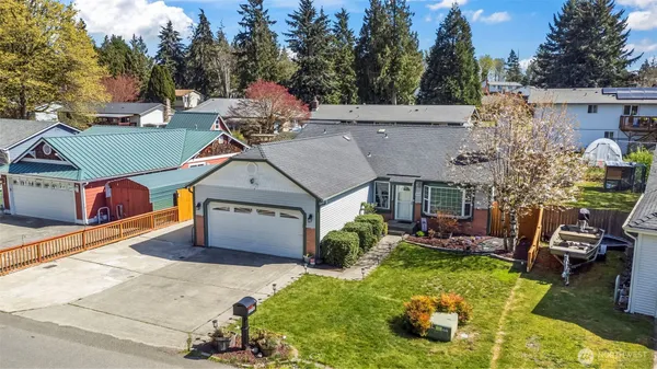 a aerial view of a house with swimming pool and a yard