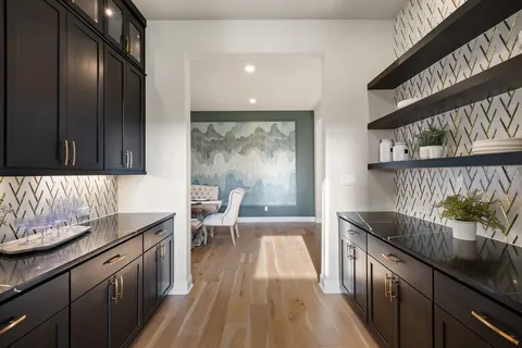 a bedroom with a large bed and a chandelier