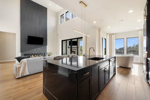 a living room with furniture and view of kitchen
