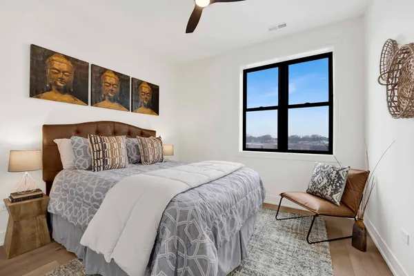 a bedroom with a bed and wooden floor