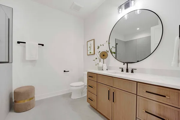 a bathroom with a toilet sink and mirror