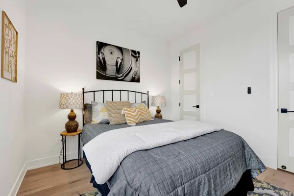 a bedroom with a bed and painting on the wall