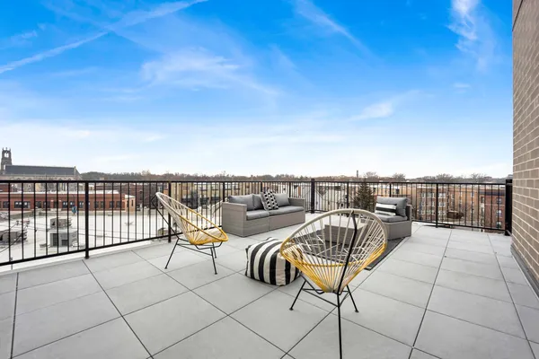 a terrace with outdoor seating and city view