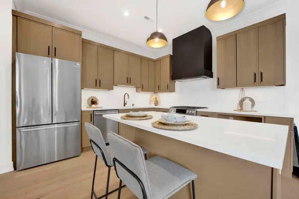 a kitchen with a refrigerator a stove a sink and a cabinets