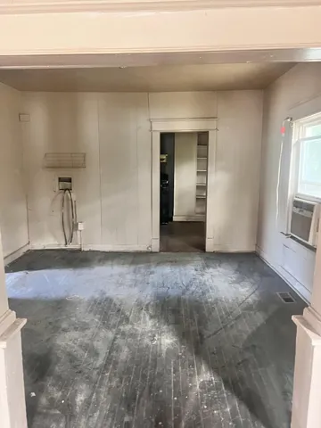a view of a livingroom with wooden floor and staircase