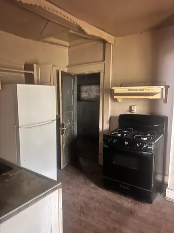 a kitchen with a refrigerator and a stove