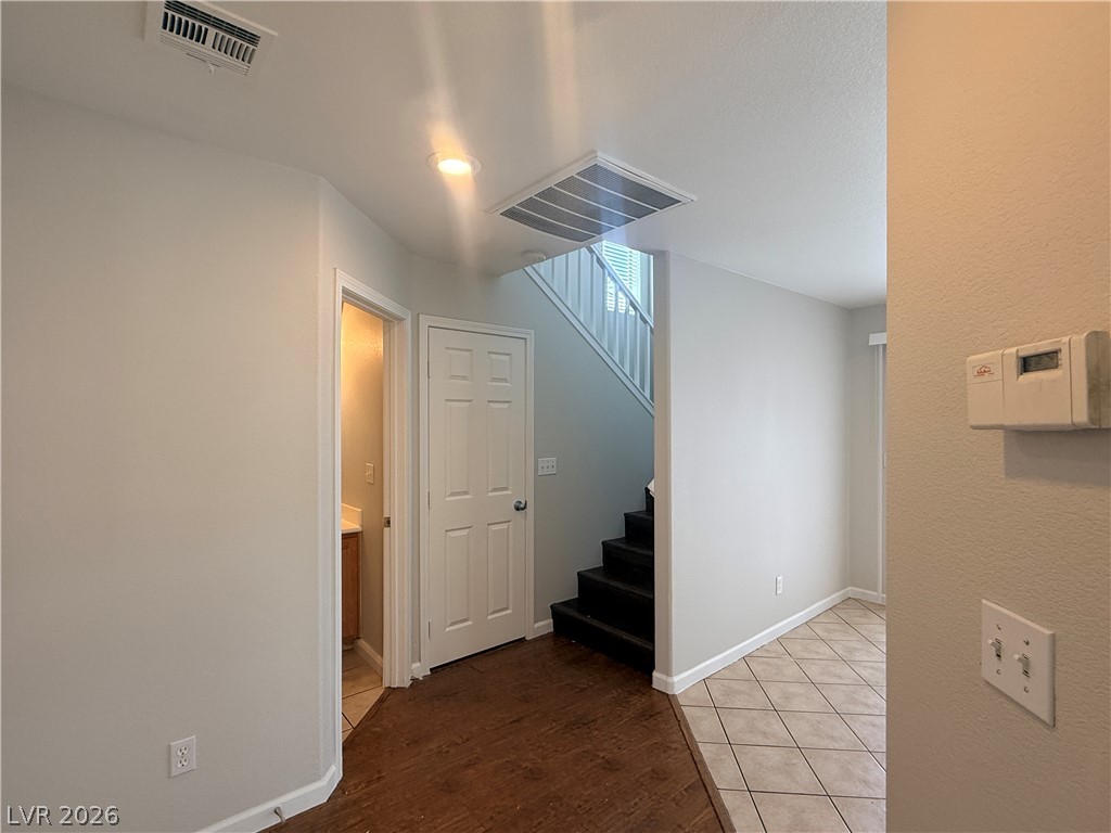11953 Fairfax Ridge Street Las Vegas, NV 89183 - Photo 14 of 32 A well-lit entry features mixed flooring and convenient access to a secondary space and staircase.
