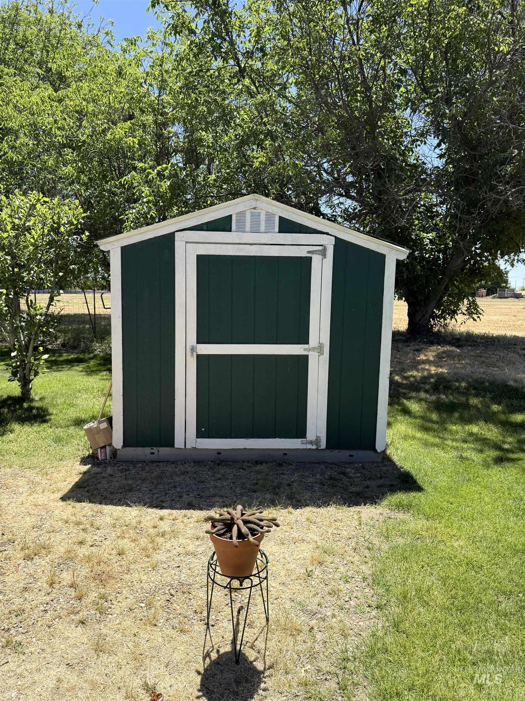 2750 Alden Road, Unit 12 12 Fruitland, ID 83619 - Photo 2 of 38 Detached storage shed featuring a gable roof, dark green siding, white trim, and a functional entry door