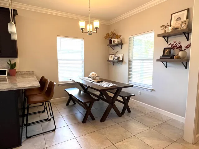 a bedroom with a bed a couch and a potted plant