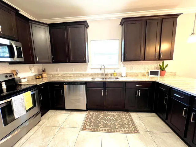 a bathroom with a granite countertop sink a shower and a mirror