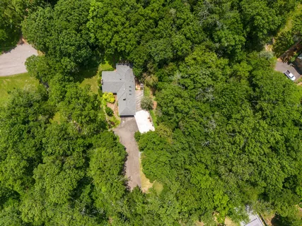 an aerial view of a house with a yard