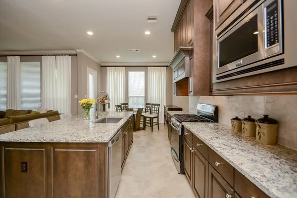 a kitchen with sink stove and cabinets