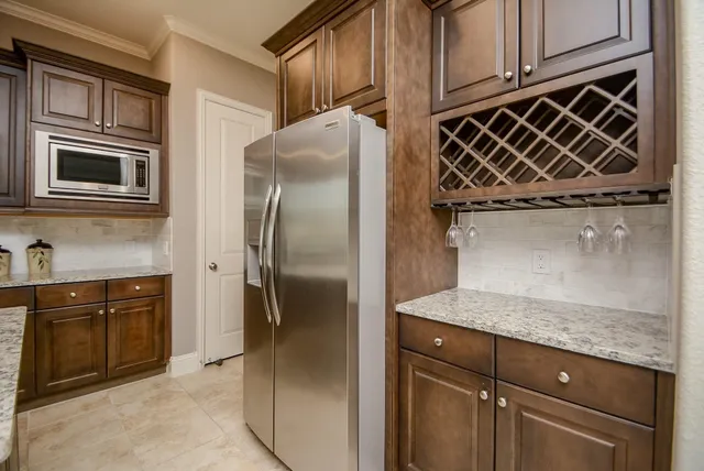 a kitchen with a refrigerator and stove