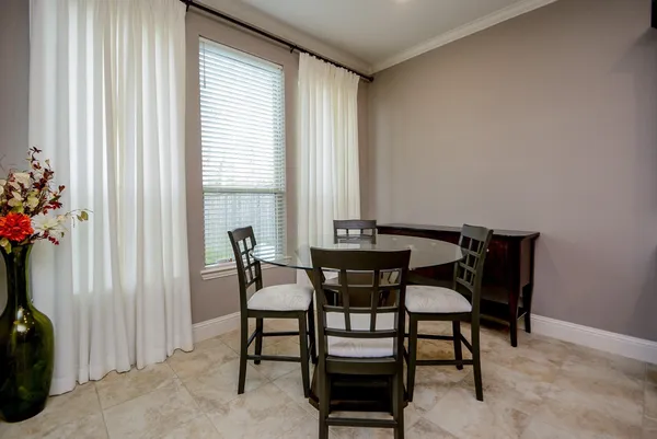 a dining room with furniture and window