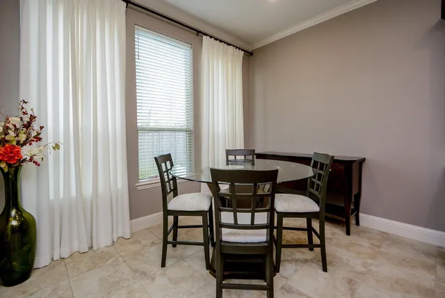 a dining room with furniture and window