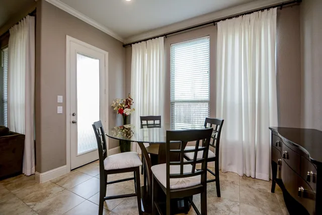 a view of a dining room with furniture and a window