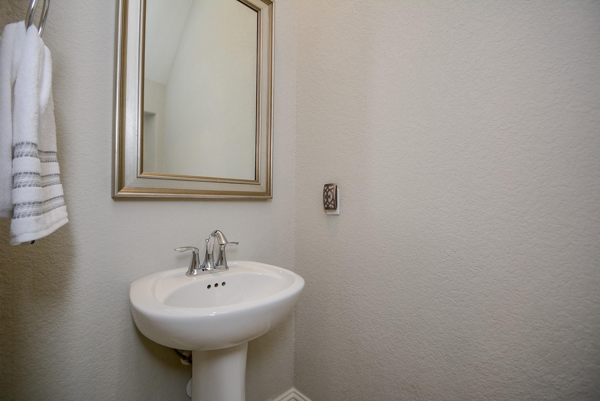 114 Silver Sky Street Conroe, TX 77304 - Photo 17 of 36 a bathroom with a sink and a mirror