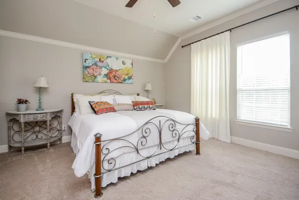 a bedroom with a bed and window