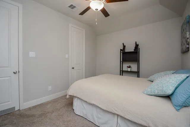 a bedroom with a bed and a tv