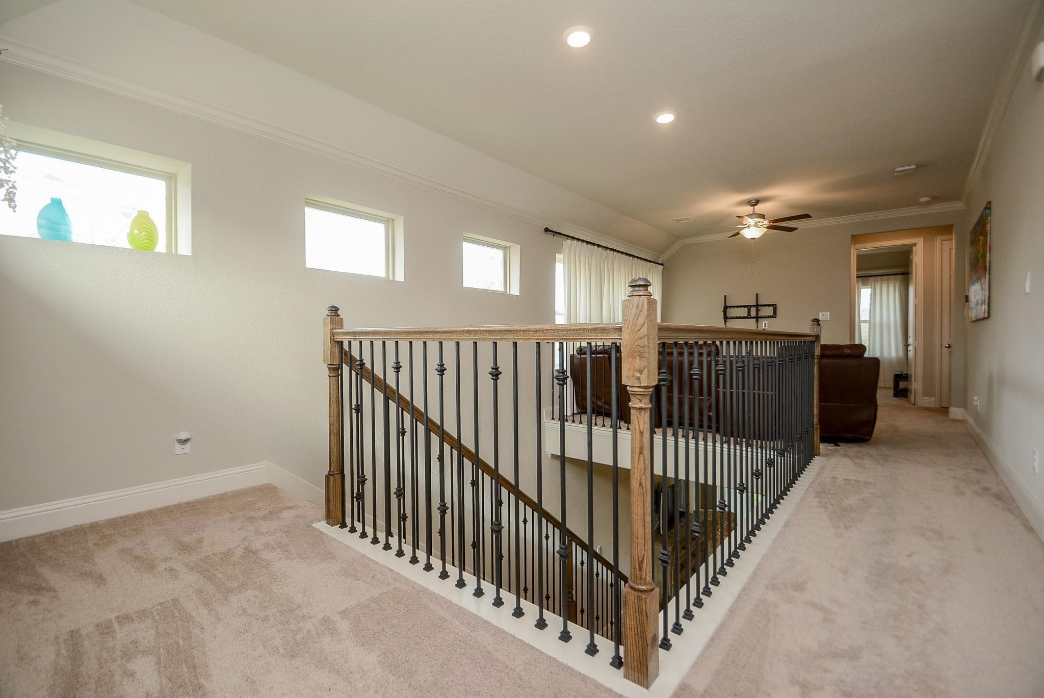 114 Silver Sky Street Conroe, TX 77304 - Photo 29 of 36 a view of a hallway with windows