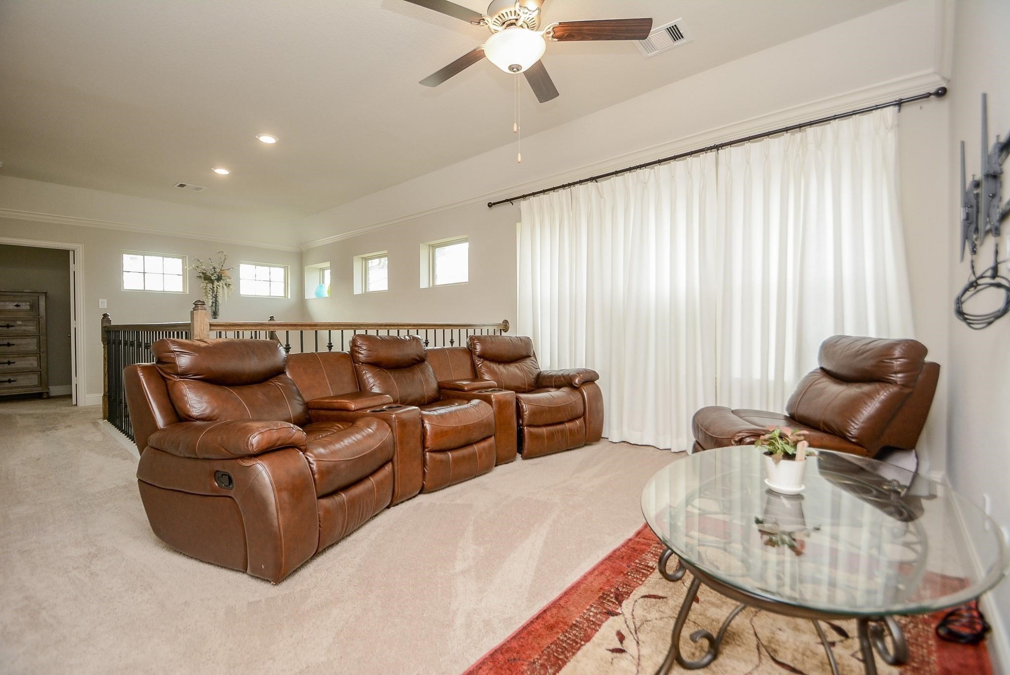 114 Silver Sky Street Conroe, TX 77304 - Photo 30 of 36 a living room with furniture and a chandelier