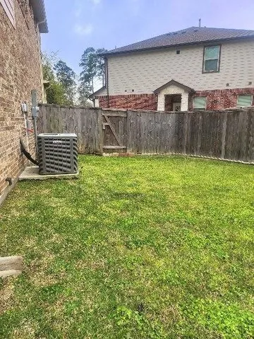a view of garden with wooden fence
