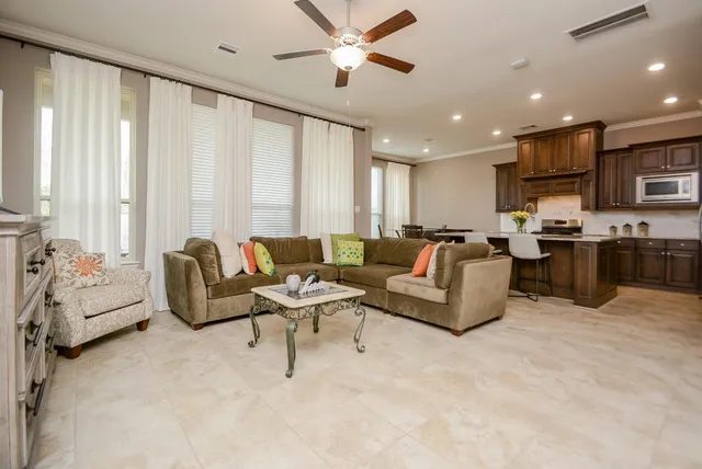 a living room with furniture and a large window