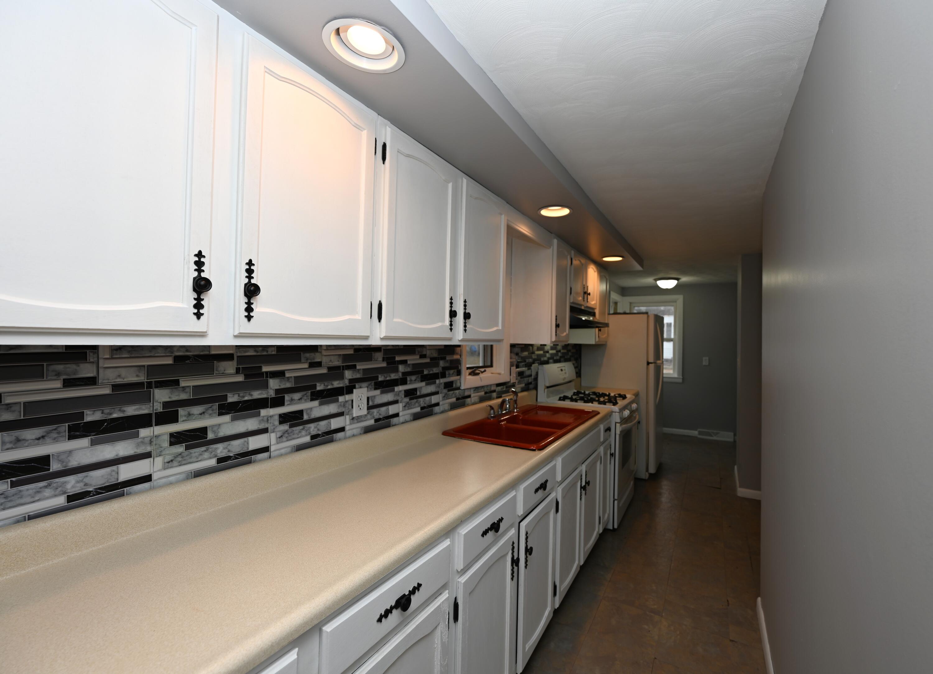 411 West Jefferson Street Winamac, IN 46996 - Photo 11 of 23 a kitchen with stainless steel appliances a sink and cabinets