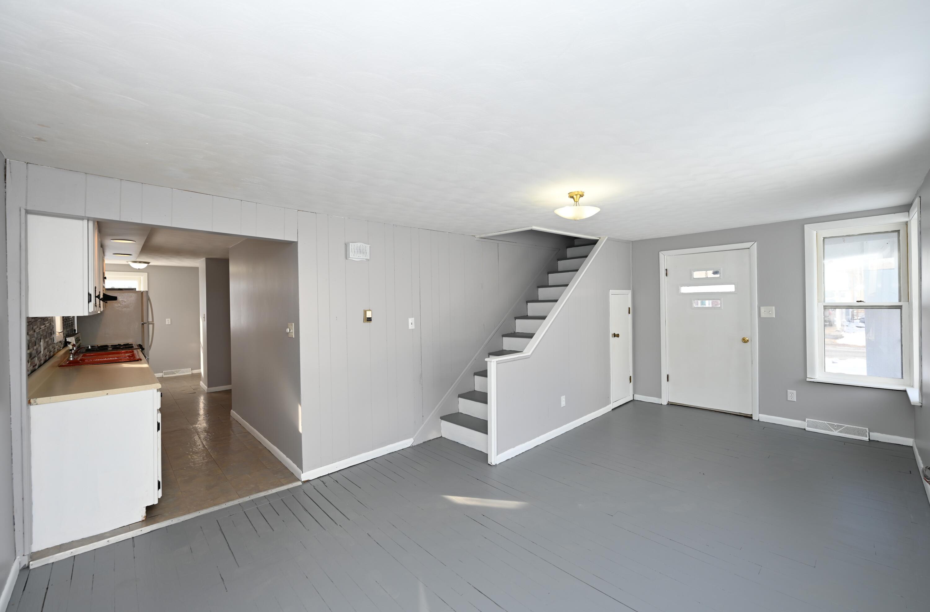 411 West Jefferson Street Winamac, IN 46996 - Photo 9 of 23 an empty room with a kitchen and a sink