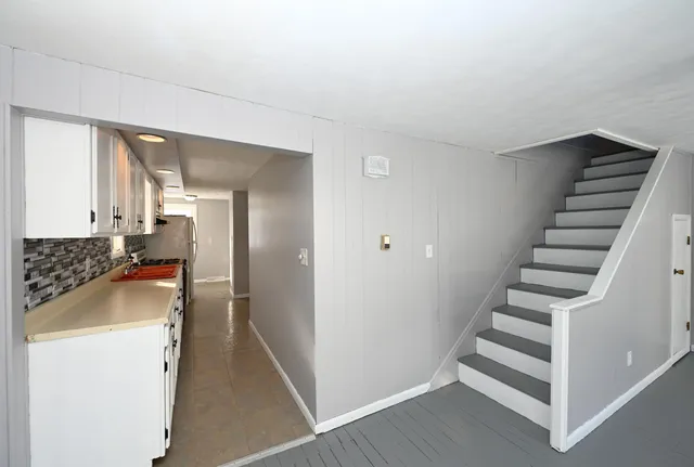 a view of a kitchen with wooden floor and electronic appliances