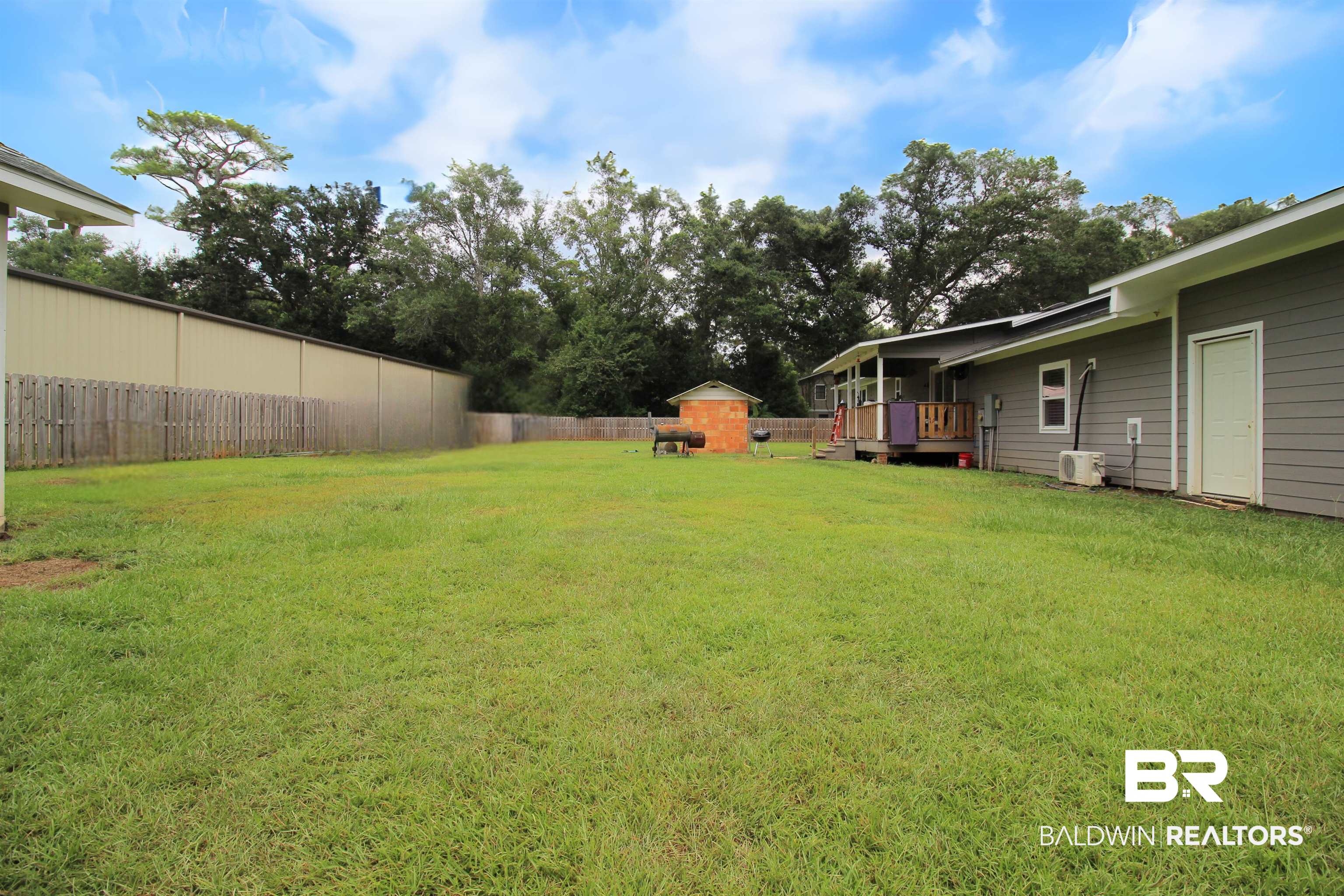 10391 County Road 64 Daphne, AL 36526 - Photo 20 of 23 View of yard with a deck