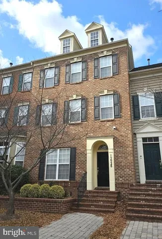 a front view of a brick house with many windows