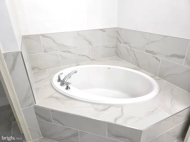 a white bath tub sitting in a bathroom