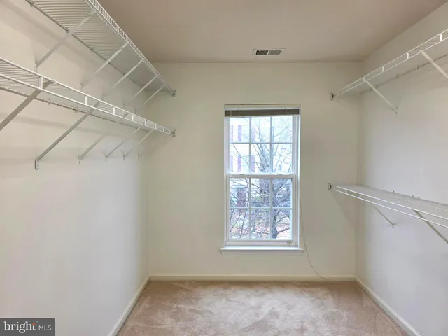 a view of a room with window and a white walls