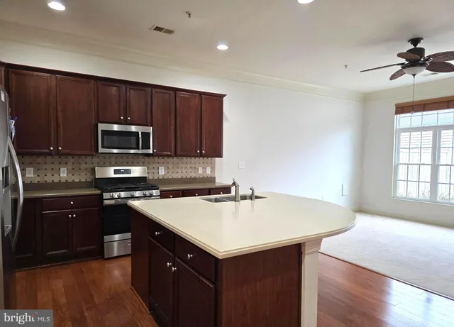 a kitchen with a stove a sink and a microwave