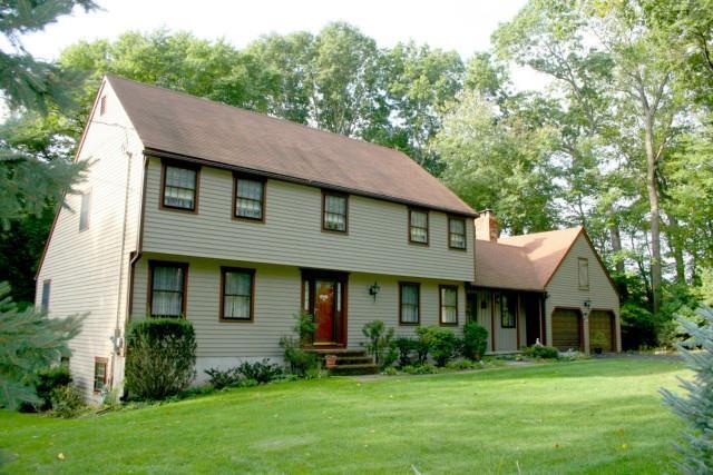 27 Powder Mill Lane Trumbull, CT 06611 - Photo 1 of 1 a front view of a house with a garden and trees