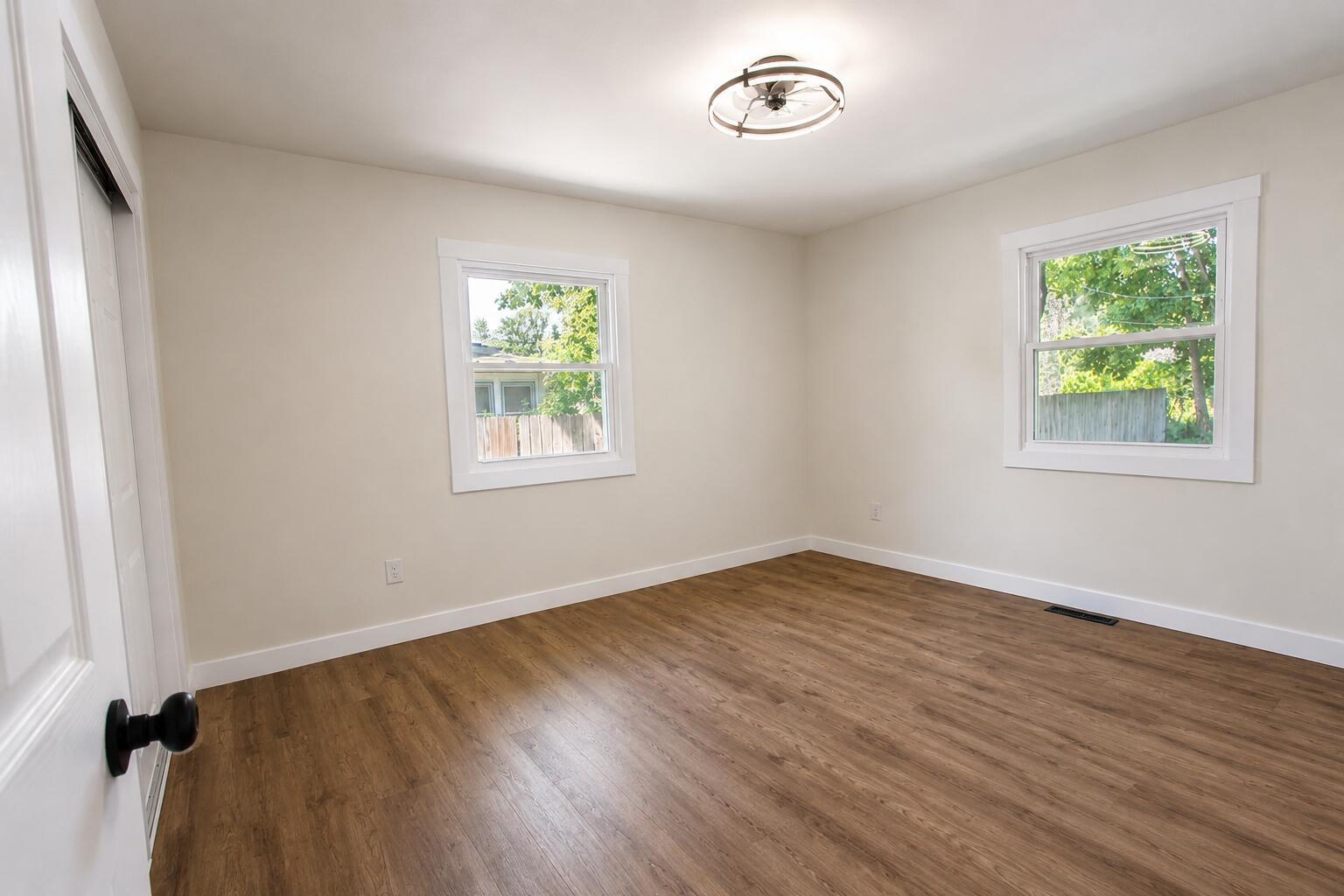 414 Holly Road Michigan City, IN 46360 - Photo 20 of 41 an empty room with wooden floor and windows