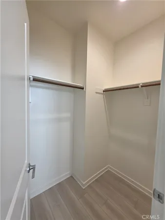 a spacious bathroom with a double vanity sink a mirror and a shower