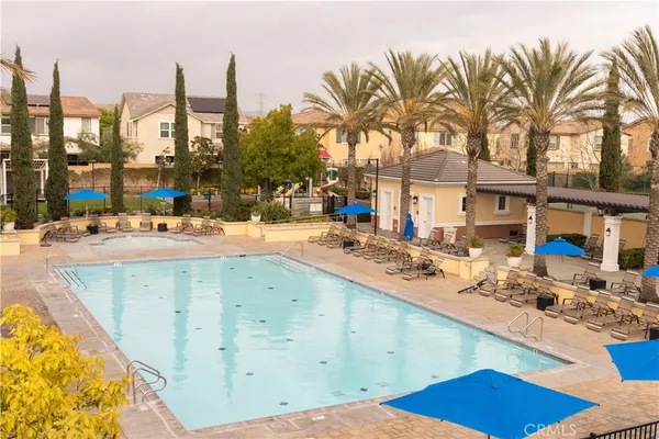 a view of a house with swimming pool and sitting area