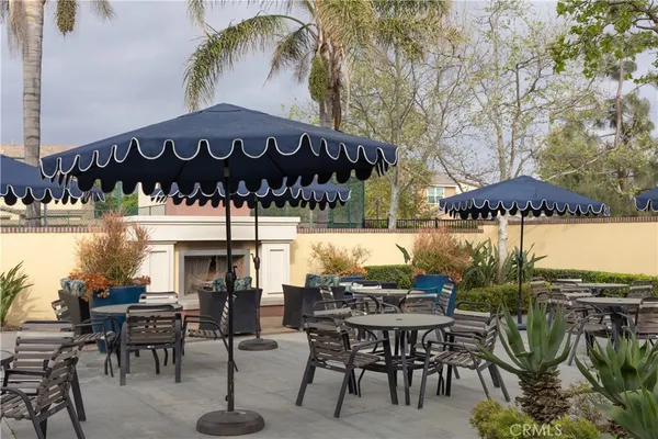 a view of a chairs and table in patio with a fire pit