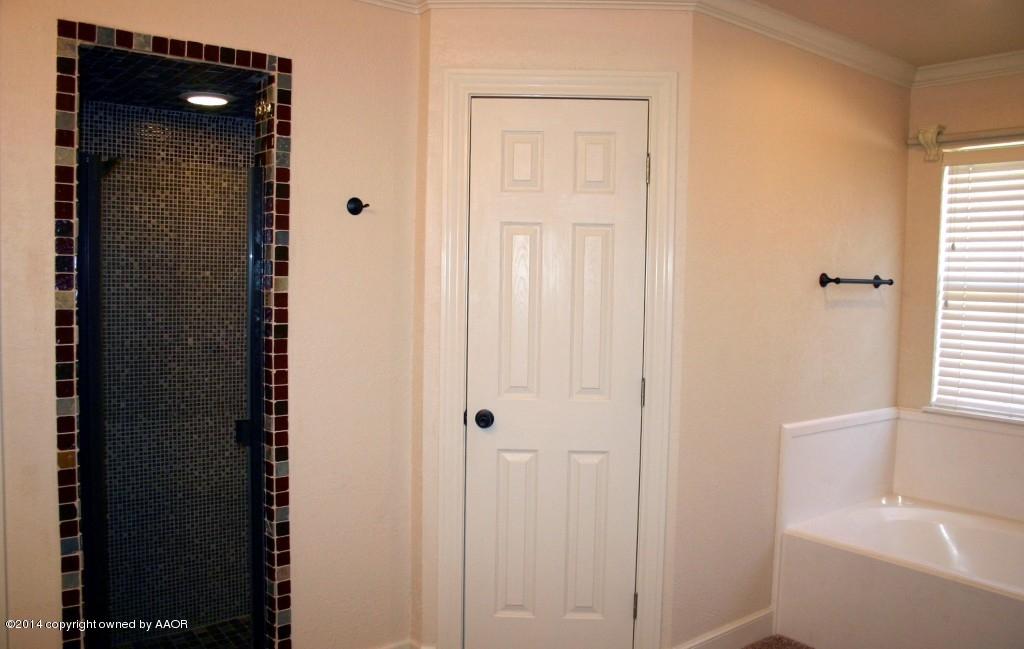5827 Nicholas Circle Amarillo, TX 79109 - Photo 14 of 23 a bathroom with a sink and a mirror