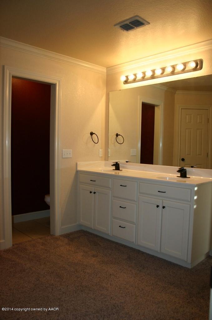 5827 Nicholas Circle Amarillo, TX 79109 - Photo 15 of 23 a spacious bathroom with a double vanity sink and mirror