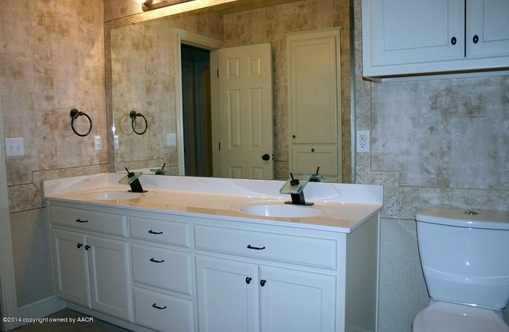 5827 Nicholas Circle Amarillo, TX 79109 - Photo 19 of 23 a bathroom with a granite countertop sink a toilet and a bathtub