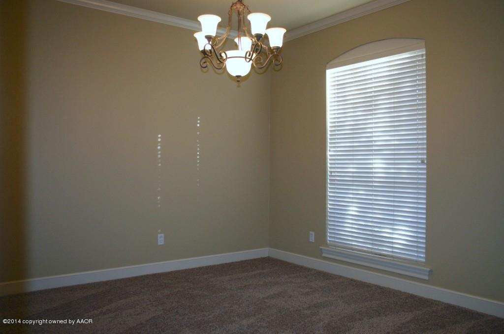 5827 Nicholas Circle Amarillo, TX 79109 - Photo 3 of 23 en empty room with windows and chandelier fan